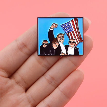 Pin’s Trump avec bras levé et drapeau usa